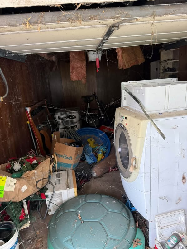 Appliances and household items awaiting removal during a property cleanout